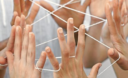 Five people playing cat's cradle, close-up
